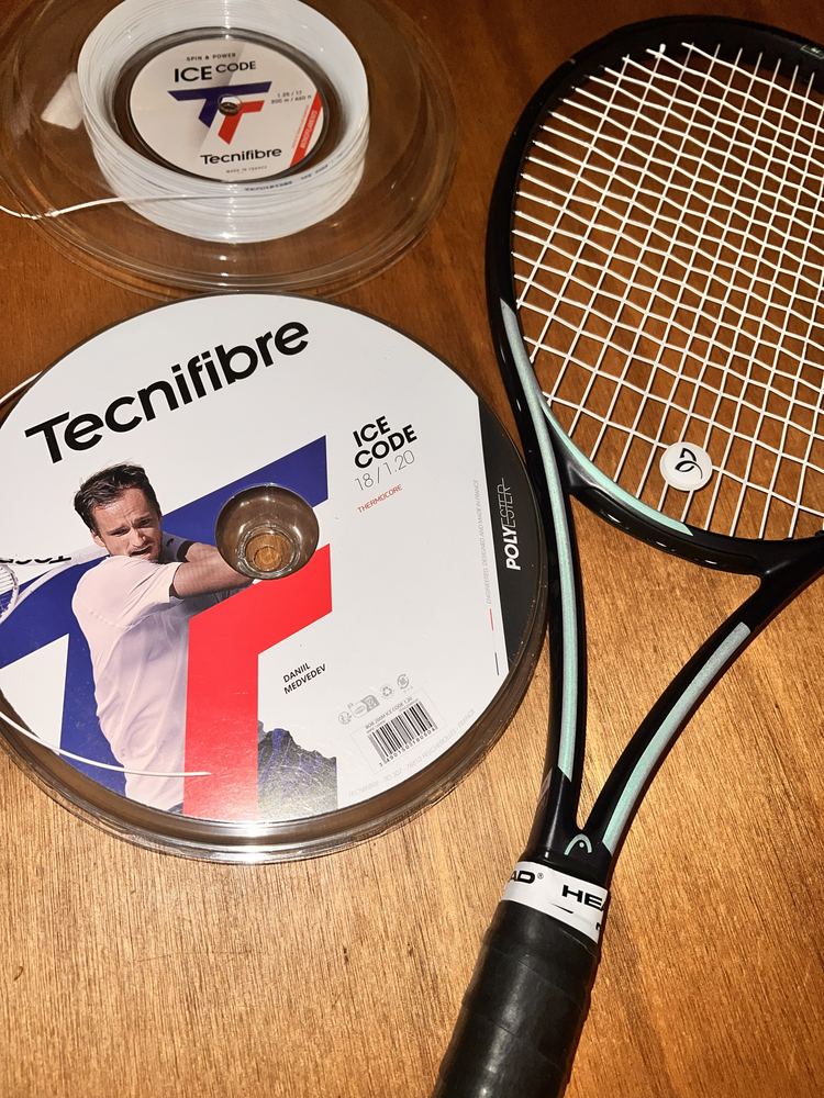 Tecnifibre Ice Code reel next to a freshly strung racket