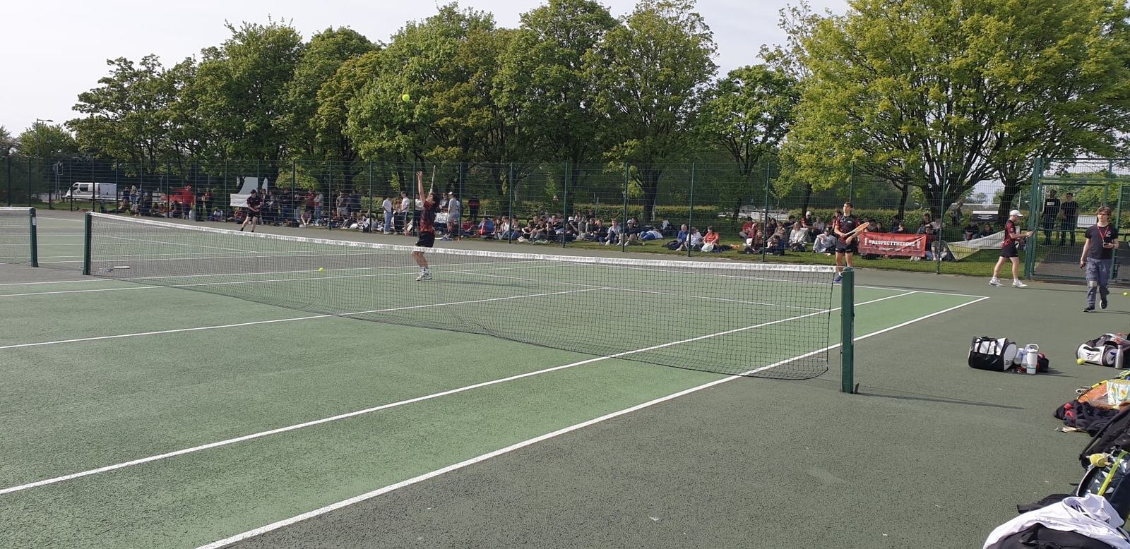 Lancaster University tennis match at Roses 2026, with a crowd watching
