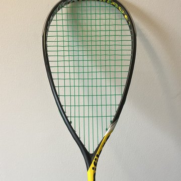 Squash racket strung with green Tecnifibre 305
