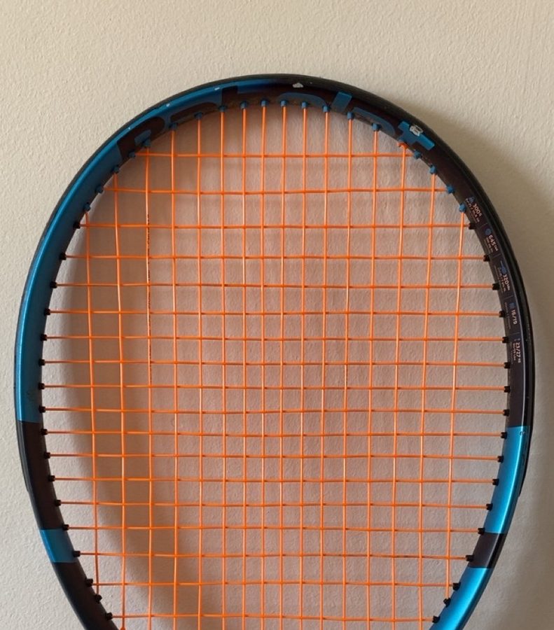 Babolat racket freshly strung with orange string